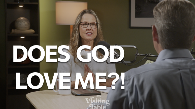 Julie Norton speaks with Ken Norton across a table on The Visiting Table set, with bold text reading "Does God Love Me?!"Ken and Julie Norton discuss what God thinks of us on The Visiting Table.